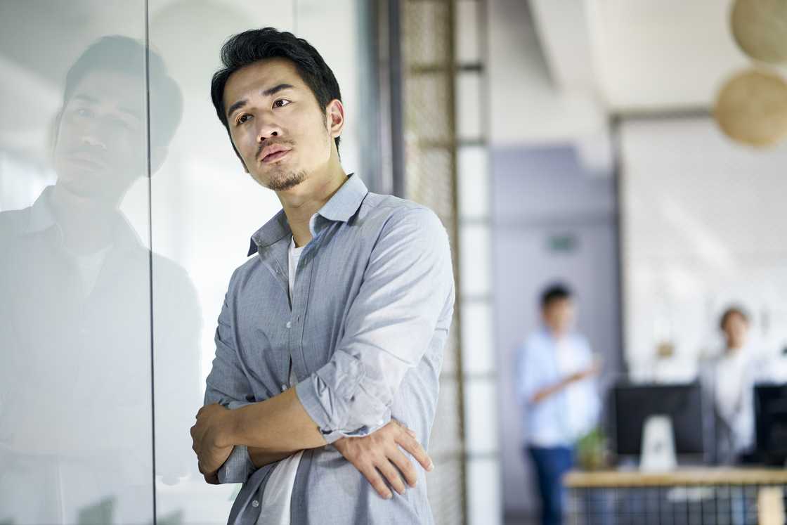A sad man talking, arms crossed