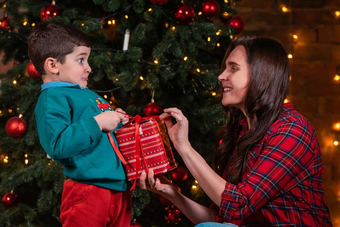 A mother giving her son a gift