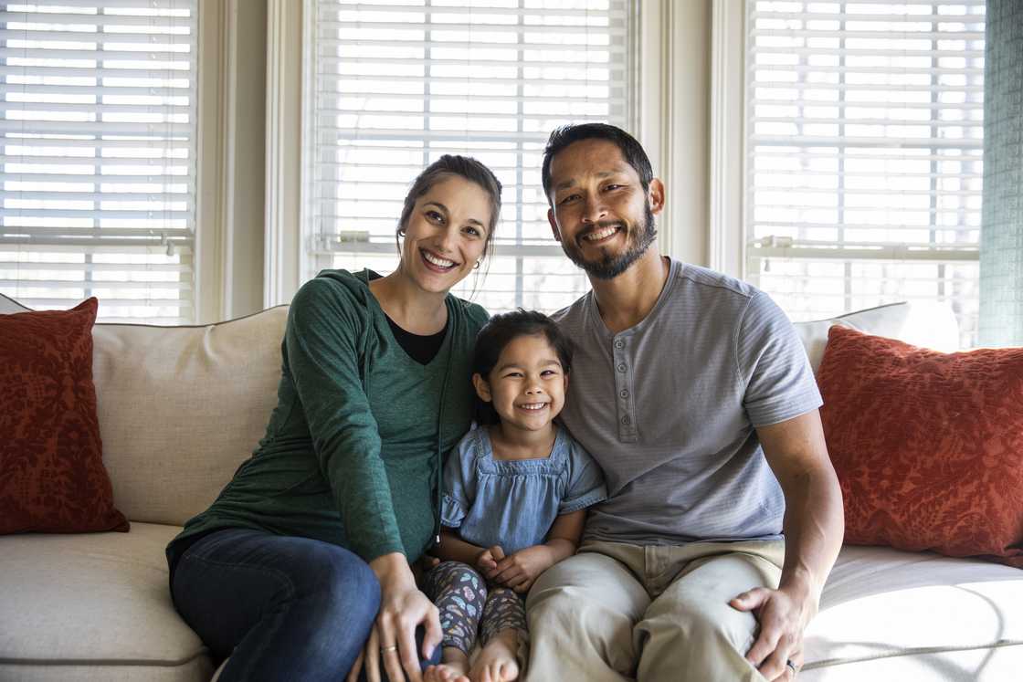 A happy couple and their daughter