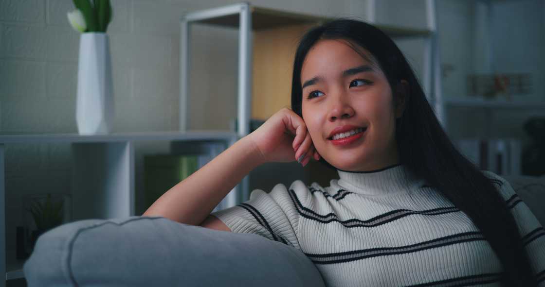 A young woman resting comfortably on the sofa in the living room A young woman resting comfortably on the sofa in the living room