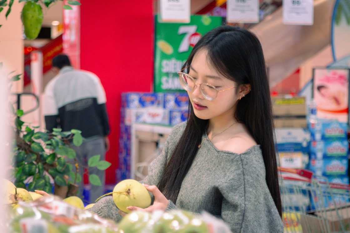 A young woman shops for fruits in a supermarket. A young woman shops for fruits in a supermarket.