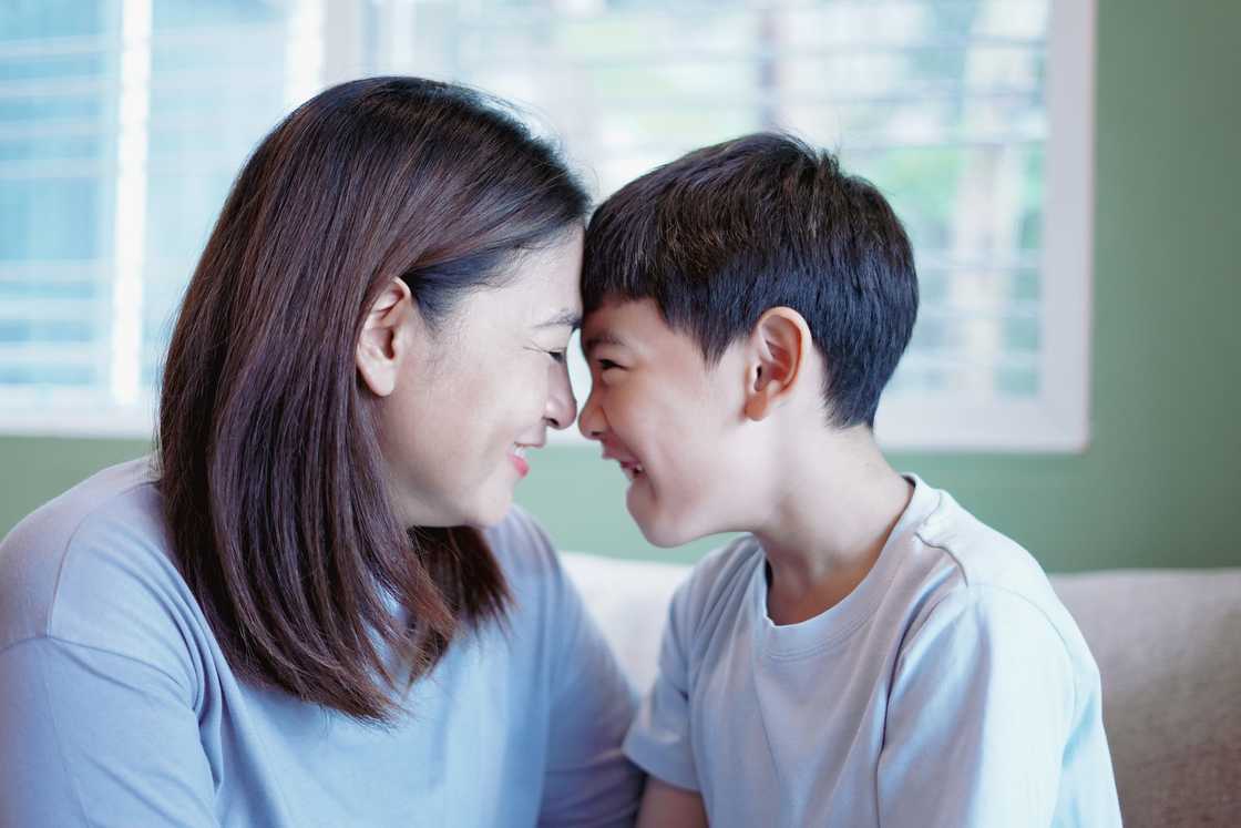 A mother and her son having a happy moment on the sofa A mother and her son having a happy moment on the sofa