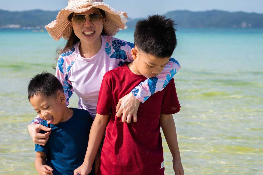 Two boys with mom on the beach Two boys with mom on the beach