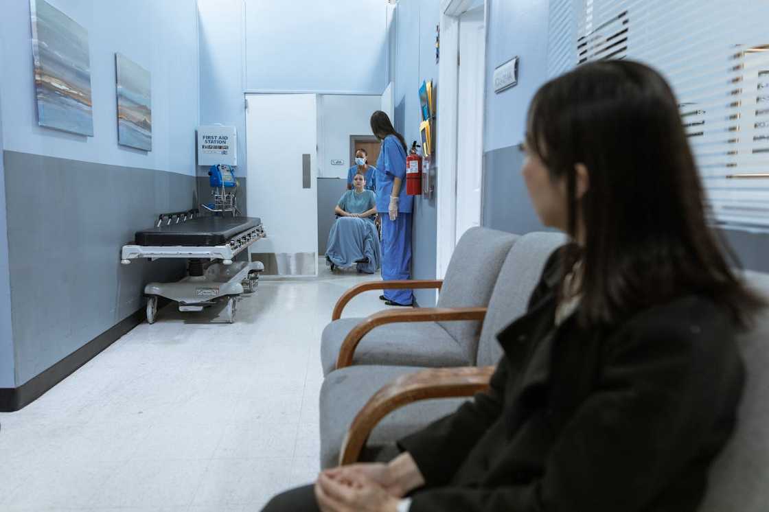 A distressed woman staring in a hospital.