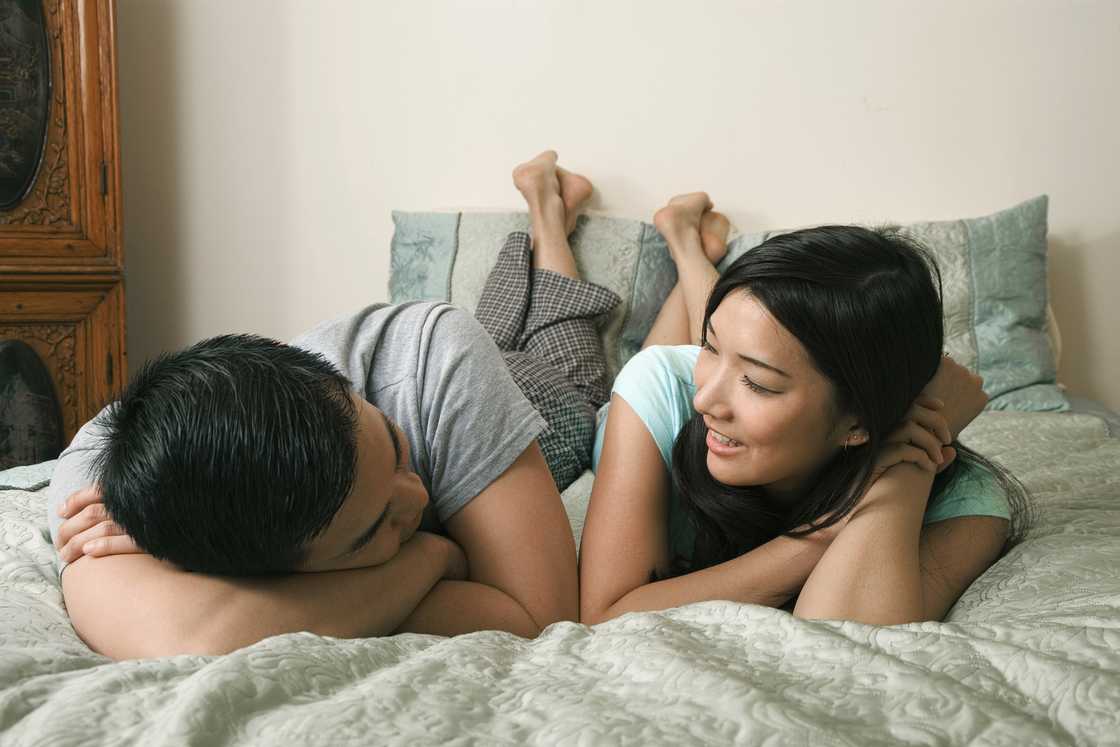 A couple relaxing on bed A couple relaxing on bed