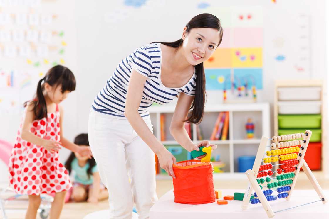 Filipino woman cleaning the playroom Filipino woman cleaning the playroom
