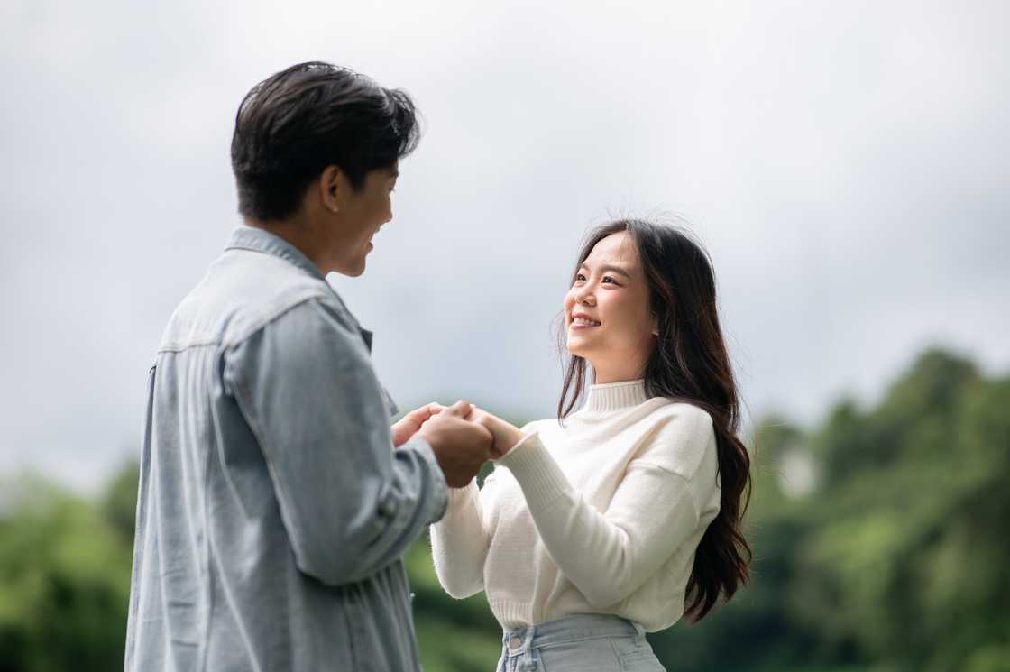 couple talking while holding both hands couple talking while holding both hands