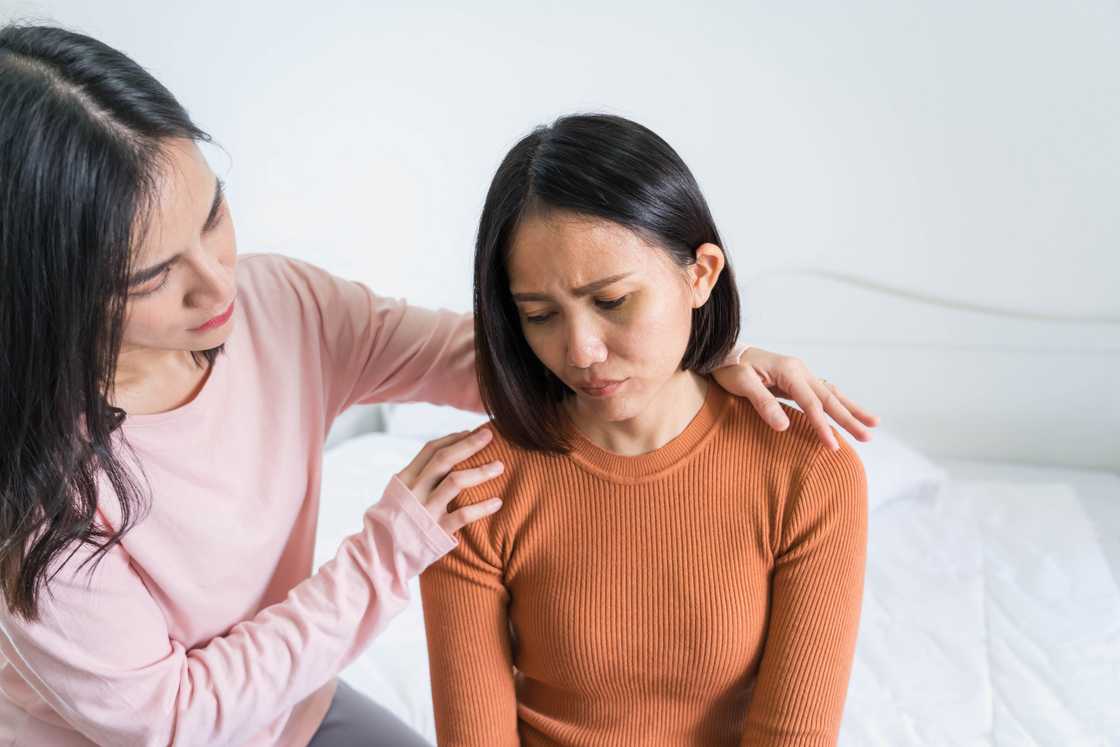 A lady consoles her sister