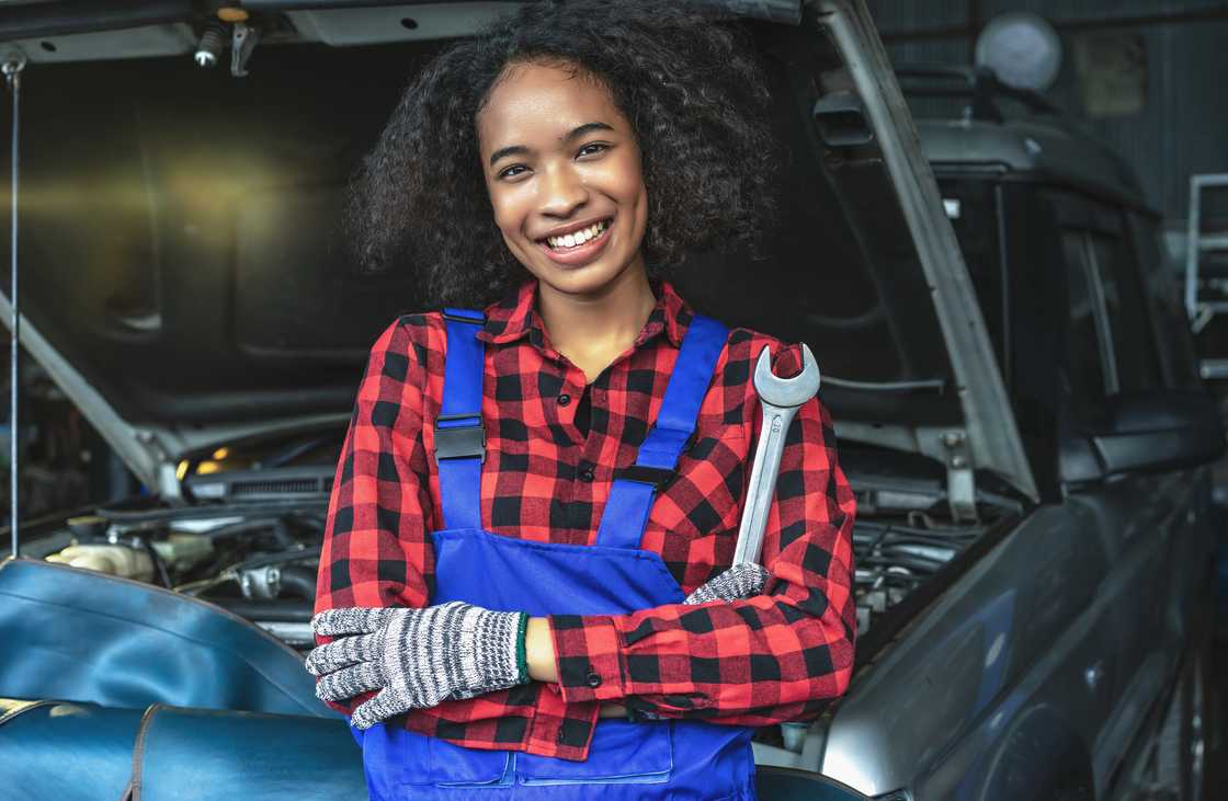 A happy female car mechanic A happy female car mechanic