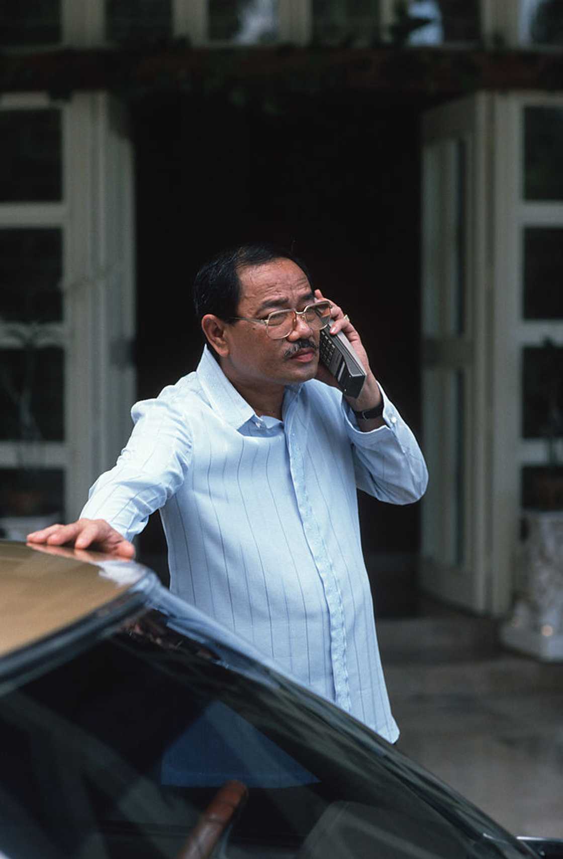 Man stands outside making a call. Man stands outside making a call.