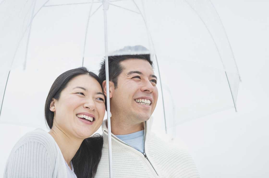 A couple sharing an umbrella
