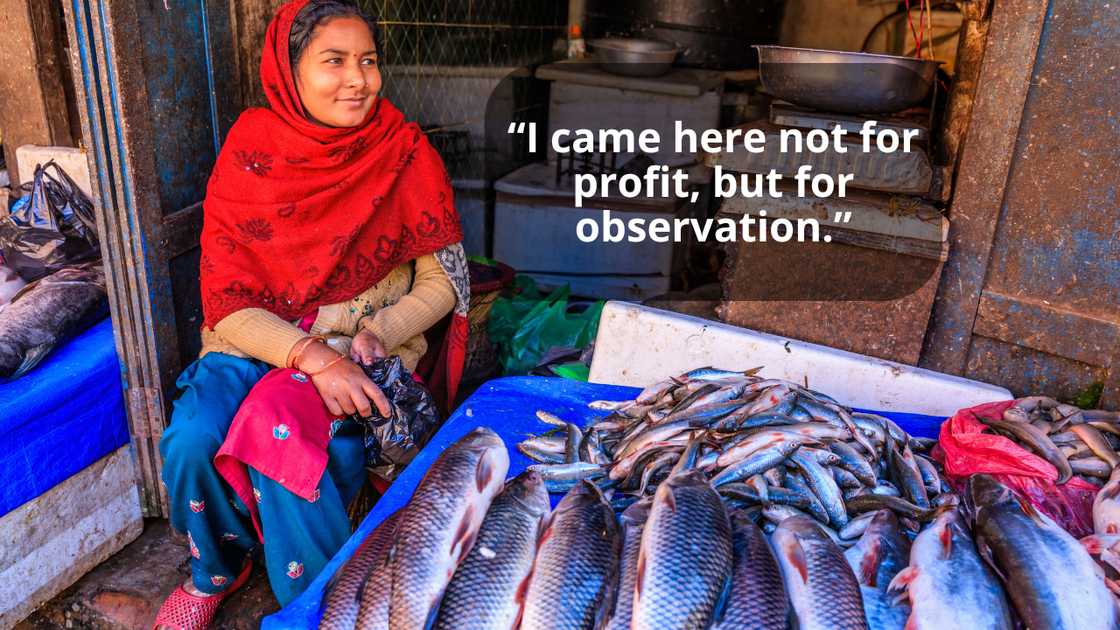 An asian woman is selling fish