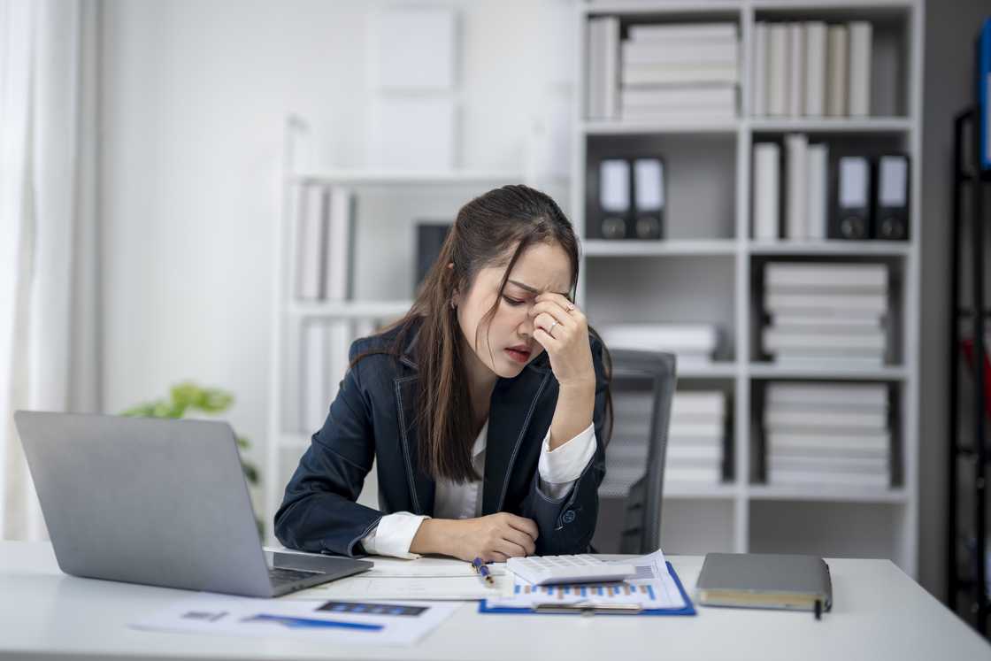 A stressed woman at work A stressed woman at work
