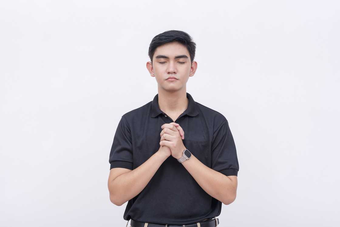 A religious young man in a black polo shirt A religious young man in a black polo shirt