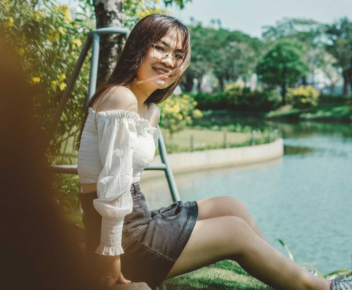 A teenage girl sitting in a park A teenage girl sitting in a park