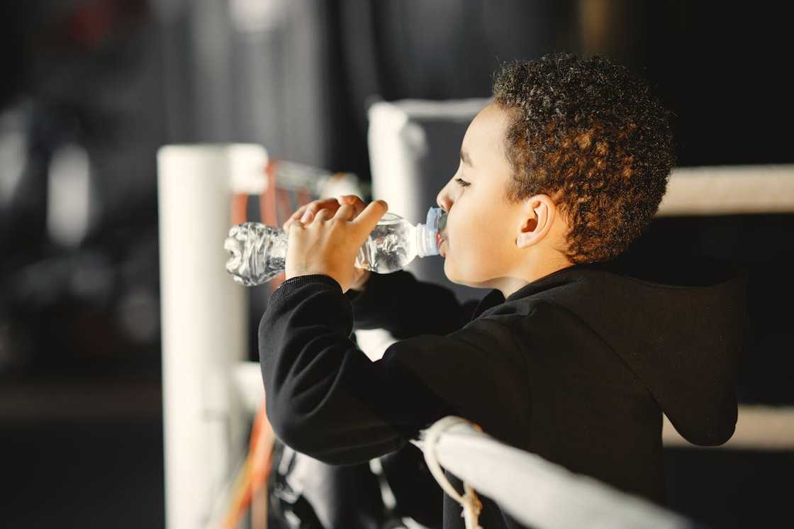 Boy drinking water from a plastic bottle. Boy drinking water from a plastic bottle.