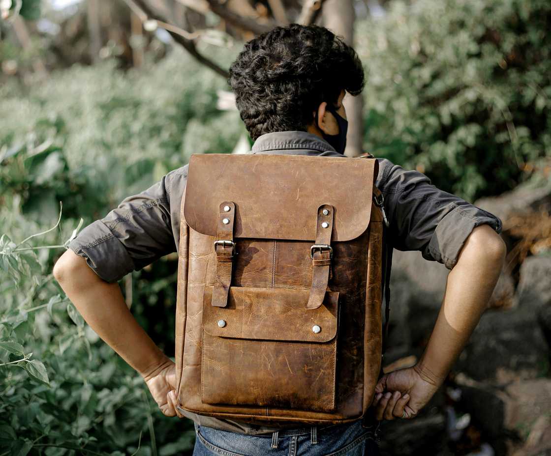 A student walking with a bag on his back A student walking with a bag on his back
