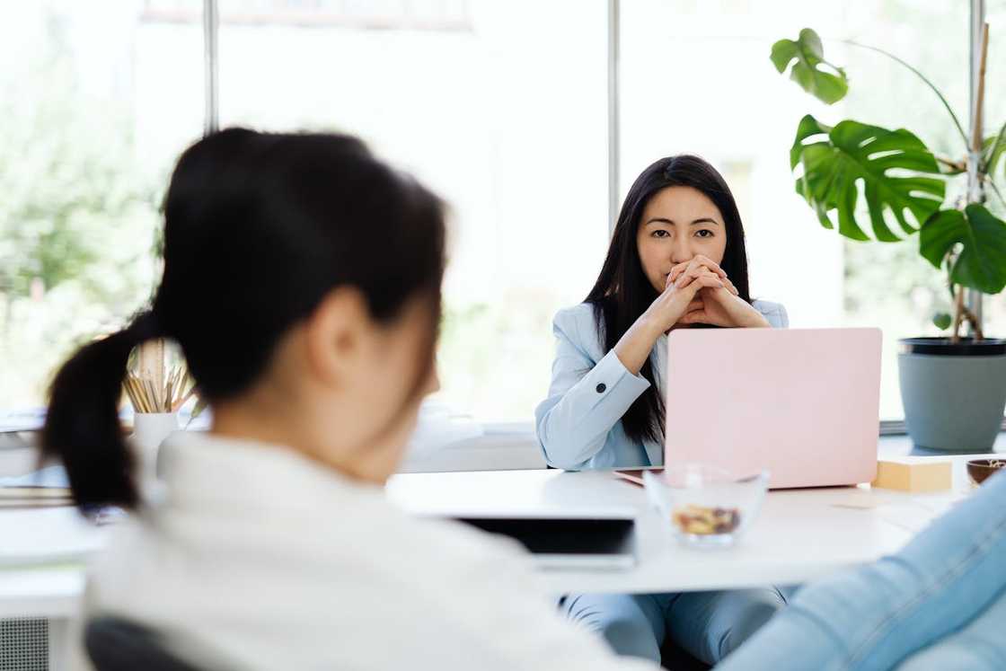 A woman sits thoughtfully in an office. A woman sits thoughtfully in an office.