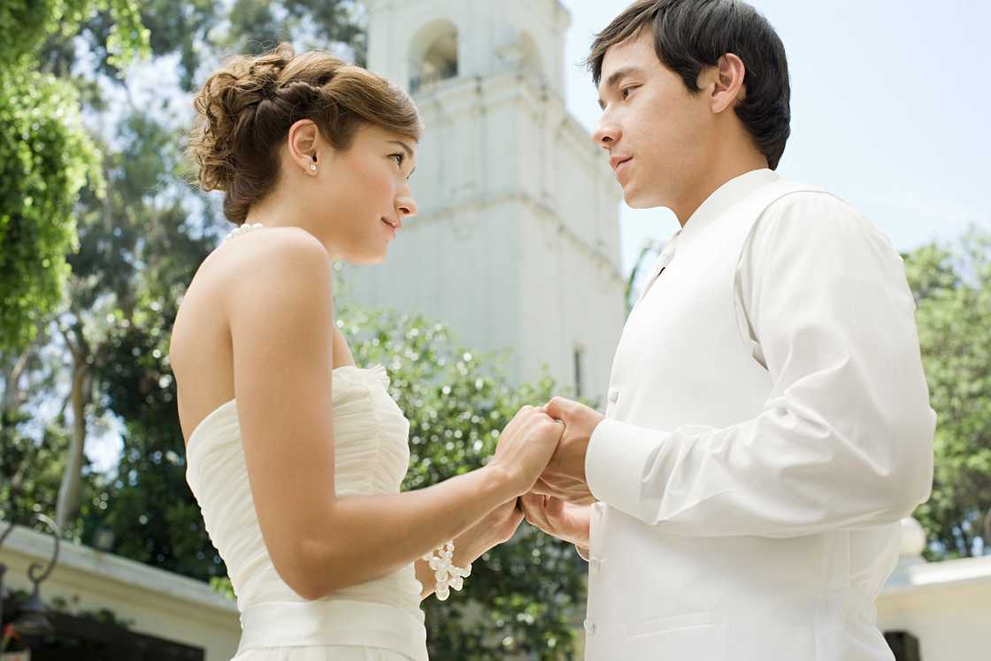 Bride and bridegroom holding hands Bride and bridegroom holding hands