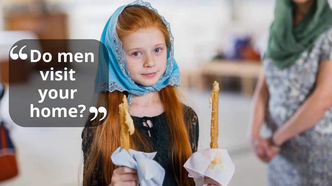 A young girl wearing a headscarf holding lit candles indoors. A young girl wearing a headscarf holding lit candles indoors.