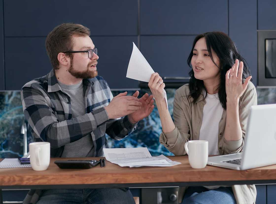 A woman confronting her boyfriend in a home workstation. A woman confronting her boyfriend in a home workstation.