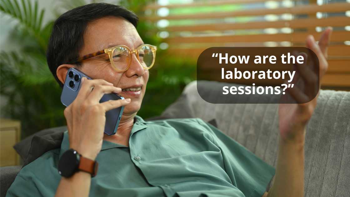 A smiling man having a pleasant conversation using his phone