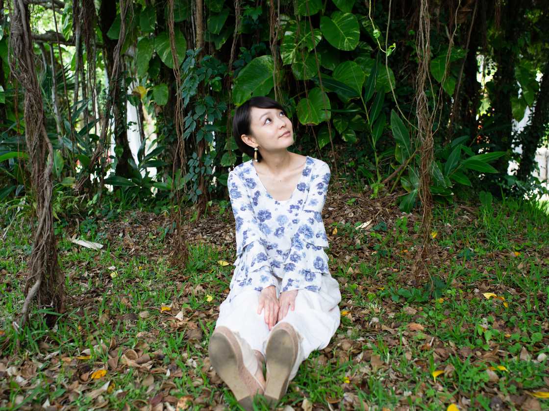 A woman sitting on grass A woman sitting on grass