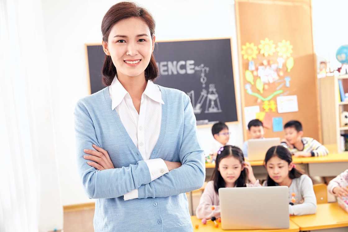 A young woman with her arms closed inside the classroom. A young woman with her arms closed inside the classroom.