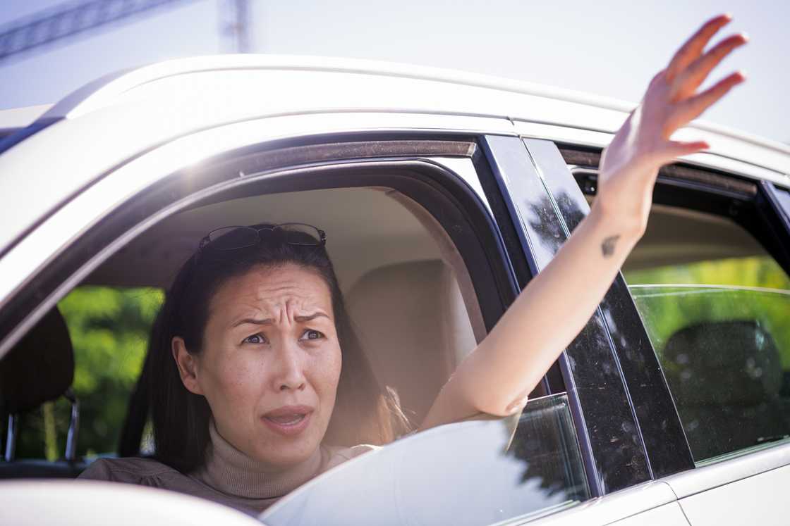 A helpless woman in a car complaining
