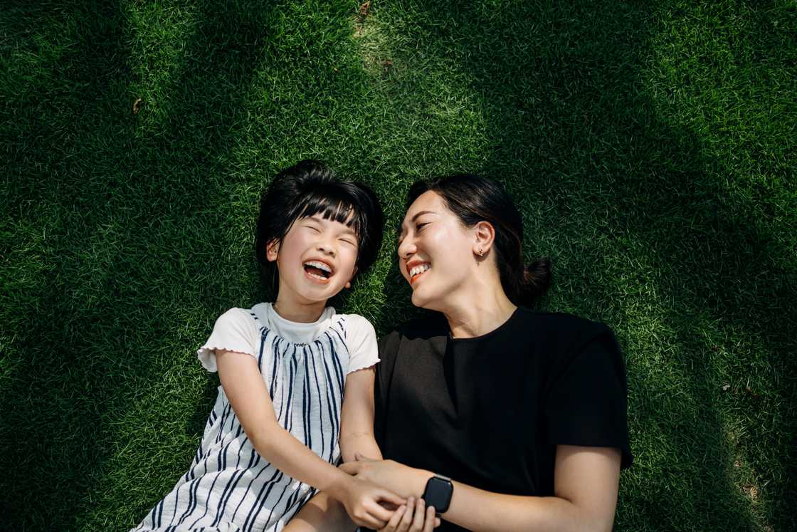 Asian woman and a child laughing