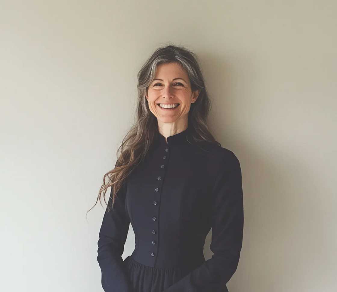 A smiling woman in a navy dress A smiling woman in a navy dress