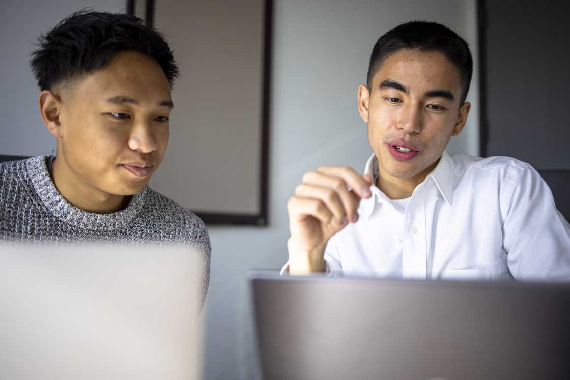 Colleagues working together on a project. Colleagues working together on a project.