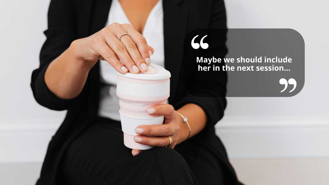 A woman talking as she holds a cup on her hands