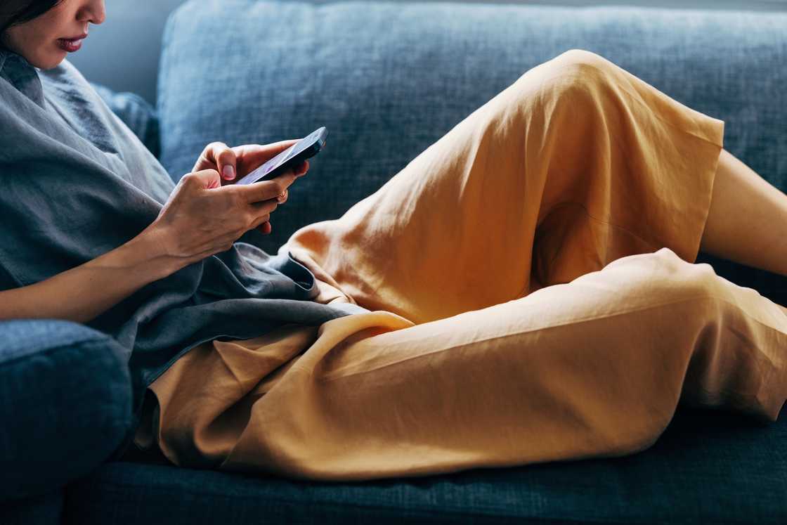 A lady scrolls through her phone A lady scrolls through her phone