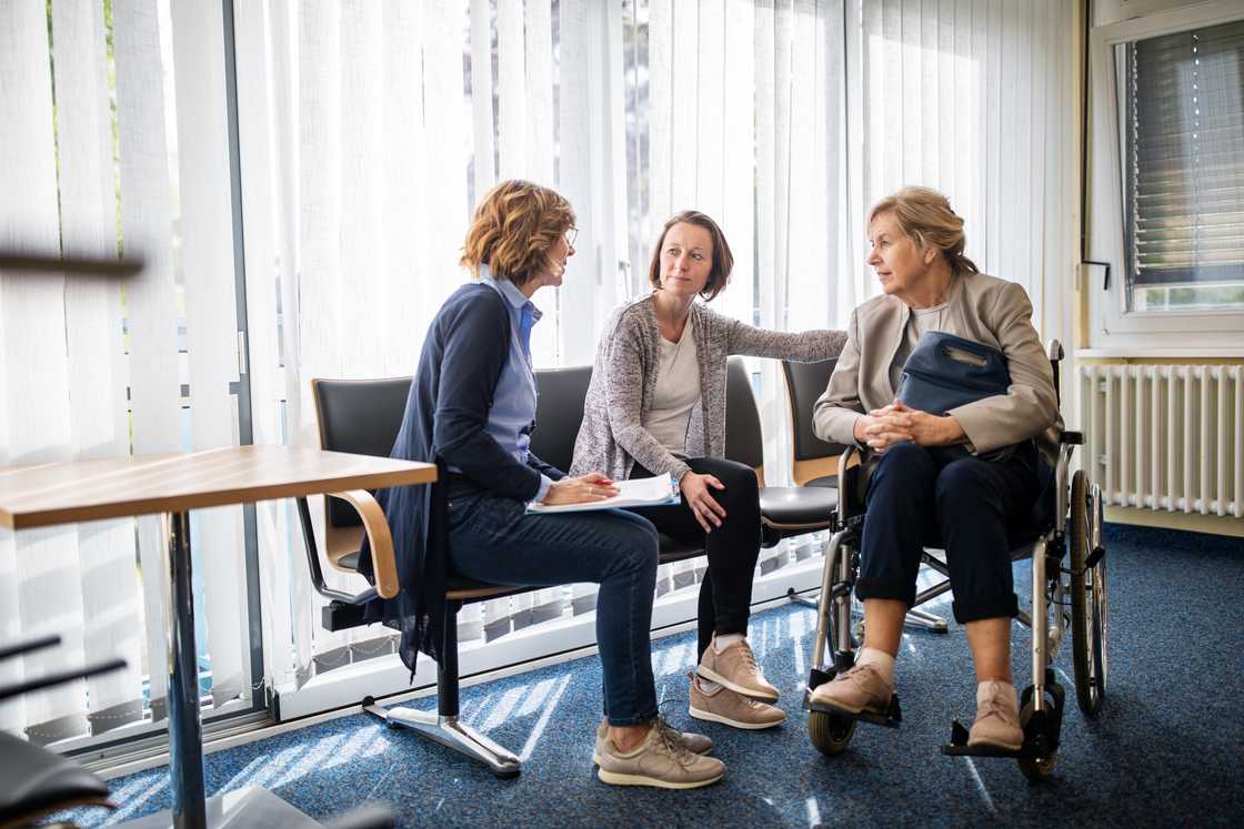 A doctor discussing with family in a hospital A doctor discussing with family in a hospital