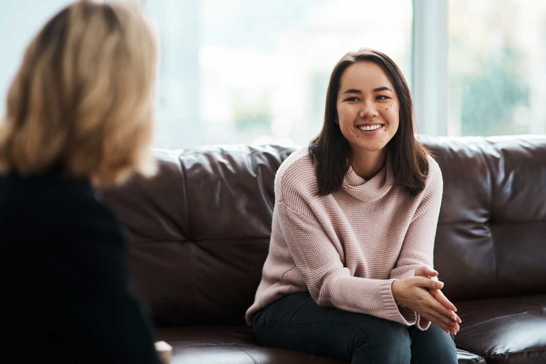 Smiling woman laughing joyfully in a therapy session Smiling woman laughing joyfully in a therapy session