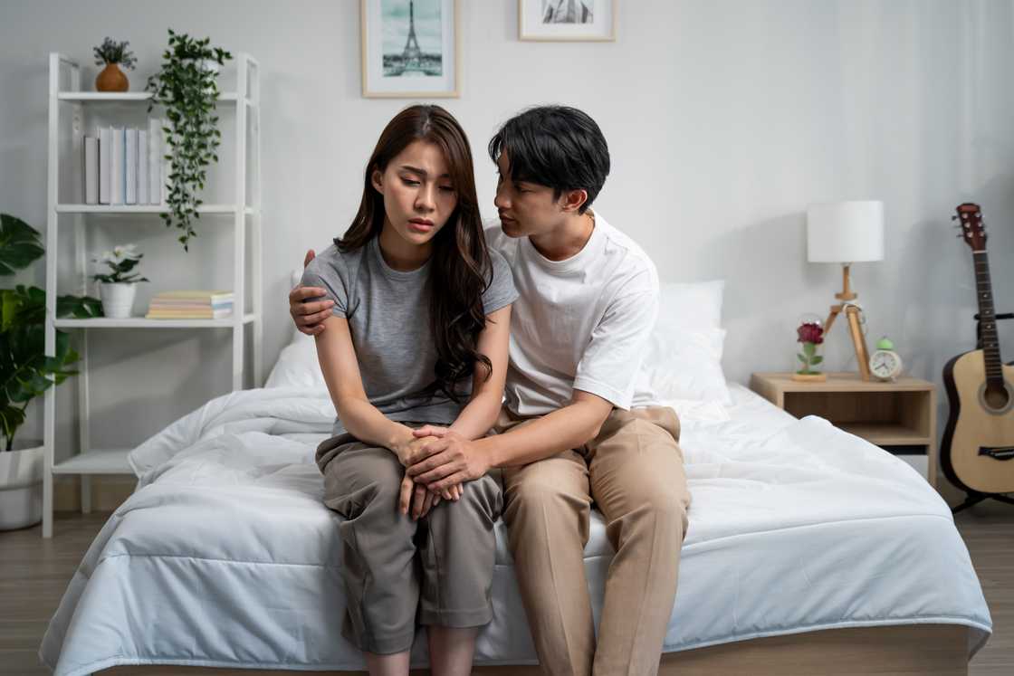 A husband comforting his wife crying and stressed wife A husband comforting his wife crying and stressed wife