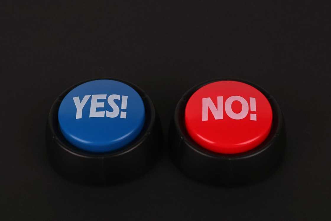 Two round buttons on a dark background, one blue labelled "Yes!" and one red labelled "No!". Two round buttons on a dark background, one blue labelled "Yes!" and one red labelled "No!".