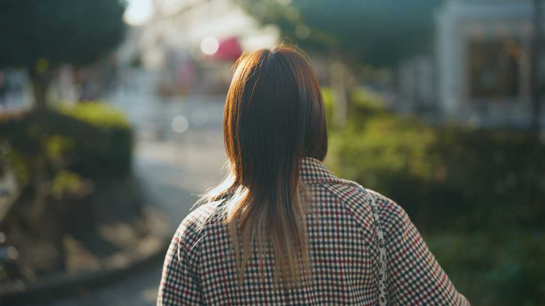 A woman walking through a peaceful urban street A woman walking through a peaceful urban street