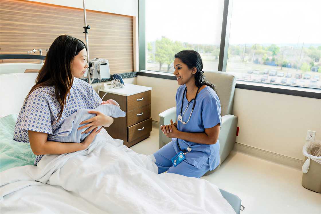 The new mother listens intently to the female doctor The new mother listens intently to the female doctor