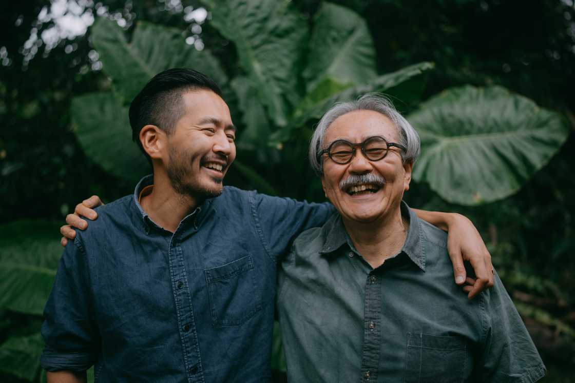 Cheerful senior father and adult son Cheerful senior father and adult son