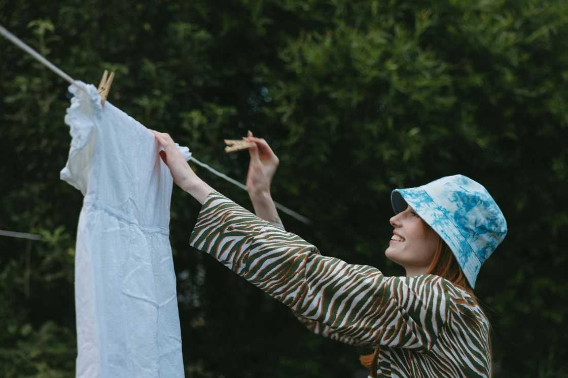 A woman hanging her clothes on the clothesline