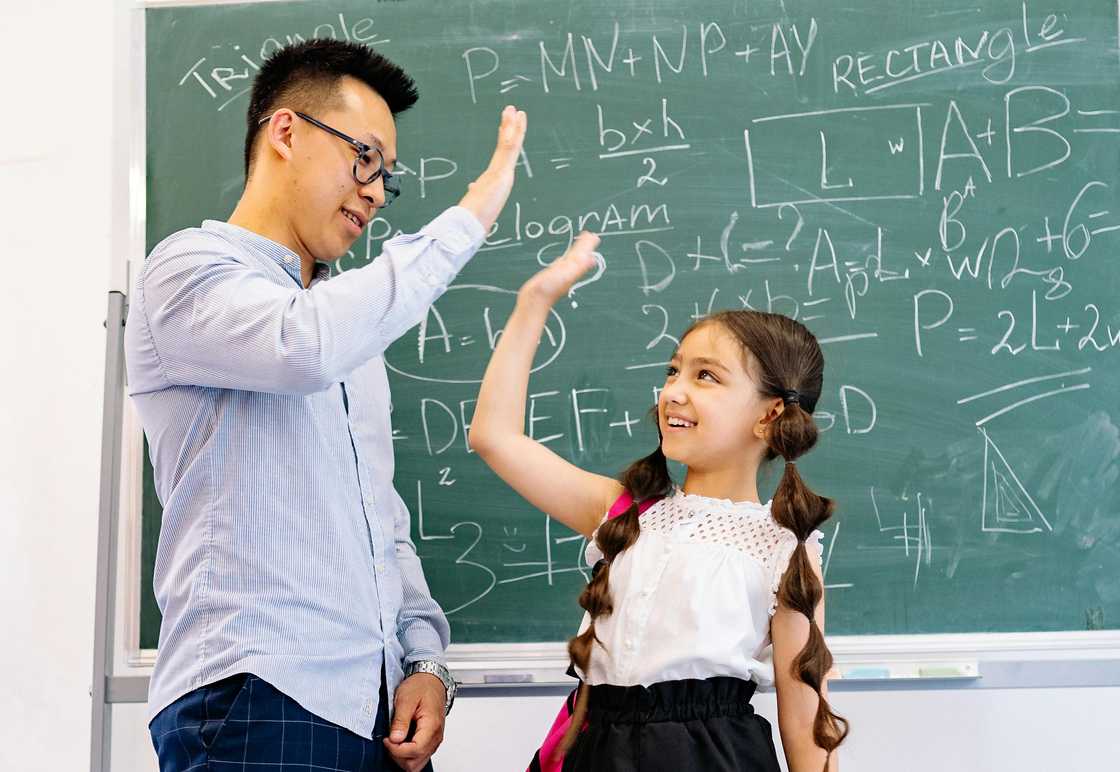 A teacher and pupil standing together before applauding audience. A teacher and pupil standing together before applauding audience.