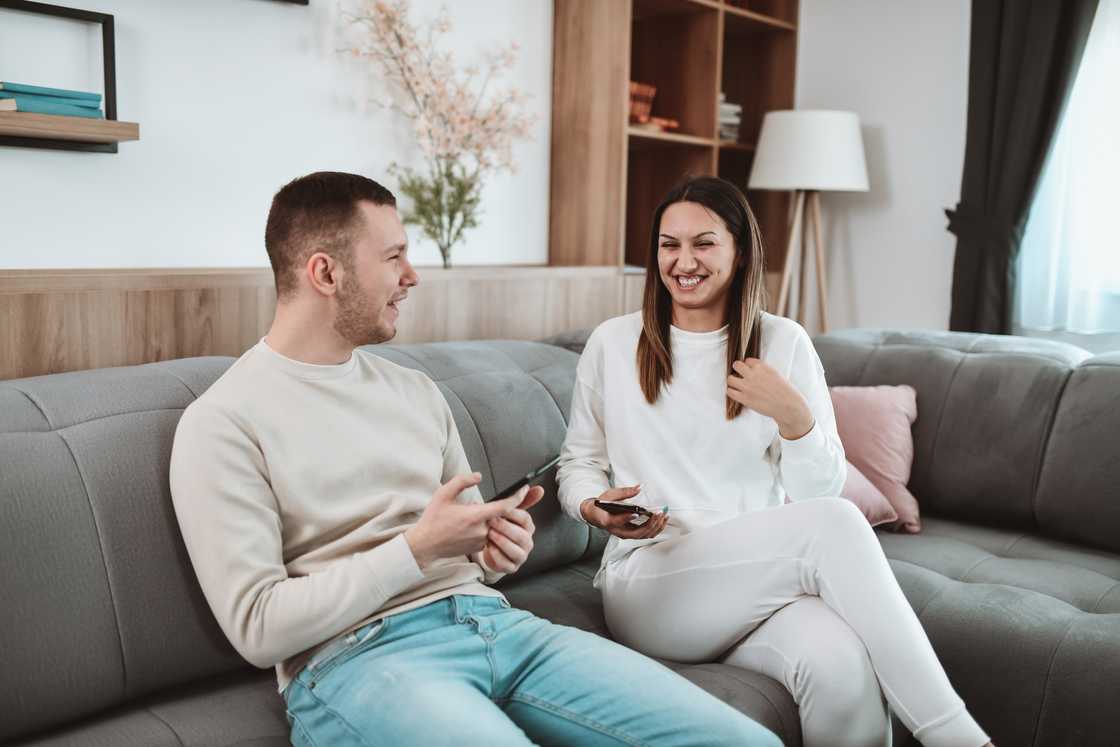 A male telling joke to his sister
