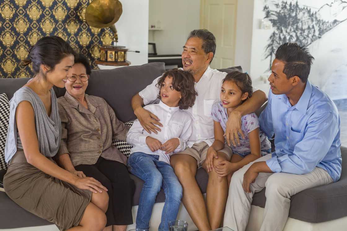 A family having fun together at home on the sofa