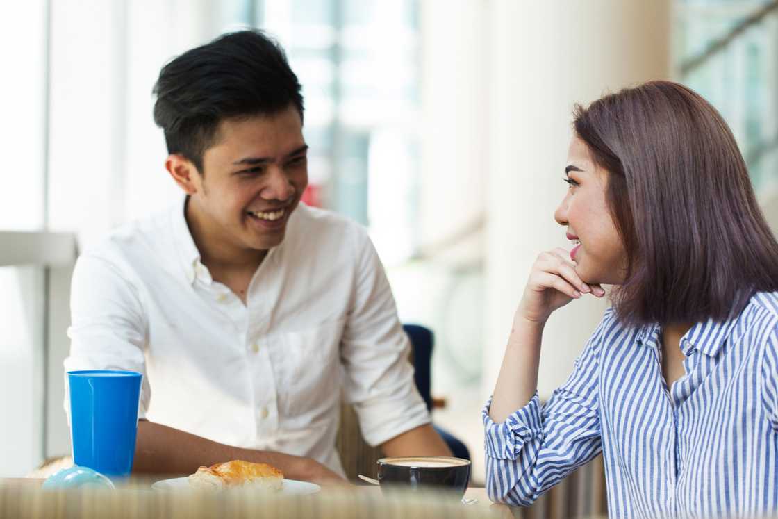 A lady and man at a cafe talking A lady and man at a cafe talking