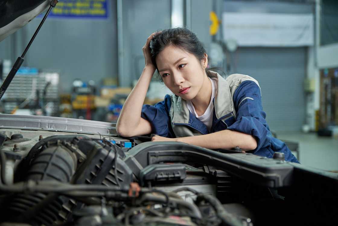 A stressed female car mechanic A stressed female car mechanic