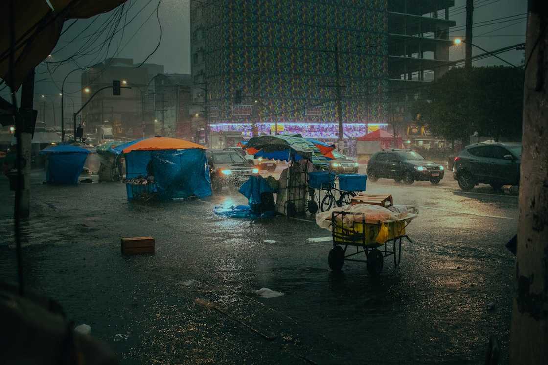 Covered stalls along a street during heavy rain. Covered stalls along a street during heavy rain.