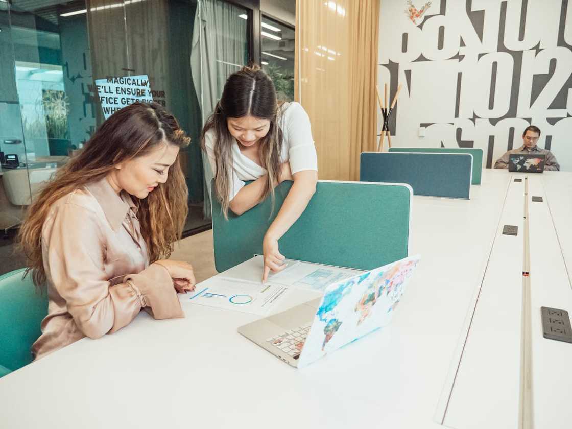 A headteacher and a parent discuss in an office. A headteacher and a parent discuss in an office.