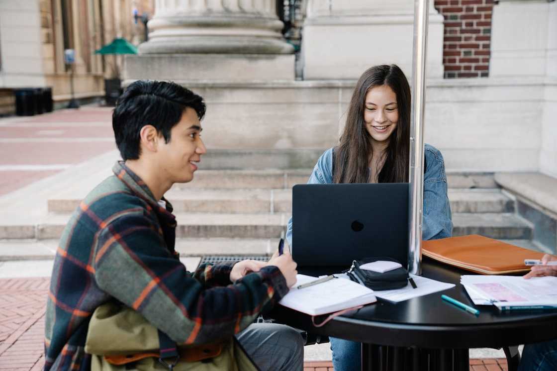 Two young professionals collaborating on case studies. Two young professionals collaborating on case studies.